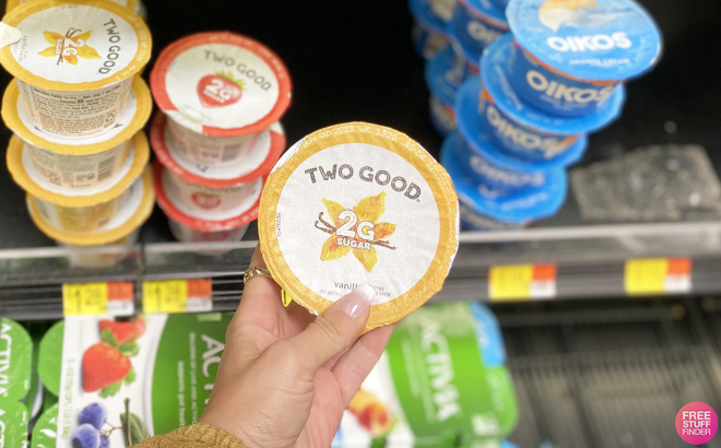Hand Holding Two Good Yogurt Cup
