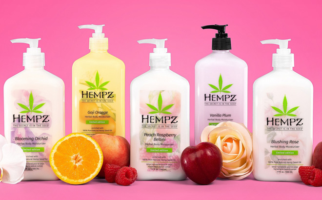 Hempz Body Moisturizers among Fruit and Flowers on a Pink Background and Surface