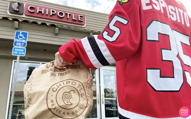 Hockey player holding a bag of Chipotle