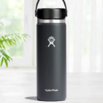 Hydro Flask Wide Mouth 20 Ounce Bottle in Stone Color on a Table