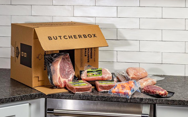 Opened ButcherBox with Meat Pieces Falling Out on a Kitchen Counter