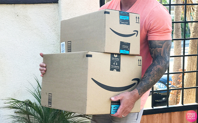 A Person Holding Amazon Delivery Boxes in Front of a Home