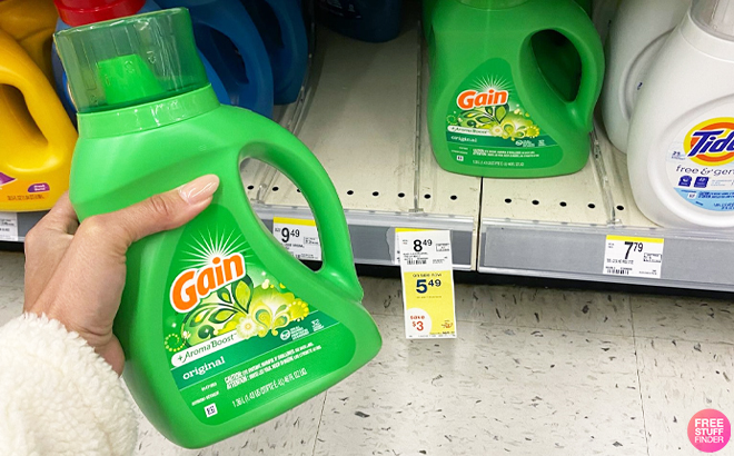 Person Holding a Gain Liquid Laundry Detergent