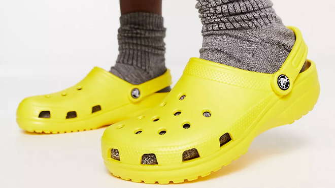 Person Wearing Crocs Classic Clogs in Lemon Color