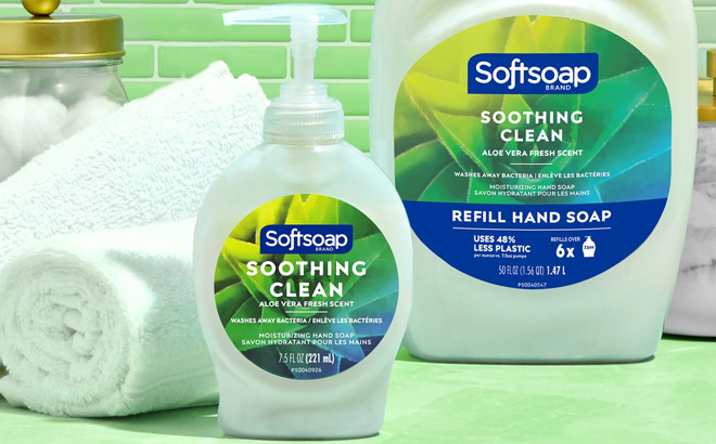 Softsoap Soothing Clean Liquid Hand Soap on a Table next to Towels and Refill Bottle