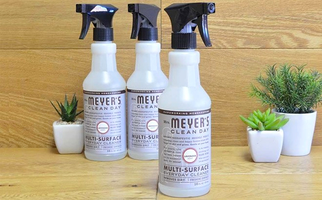 Three Bottles of Mrs Meyers All Purporse Cleaner Spray with Lavander Scent on a Tablet with Plants