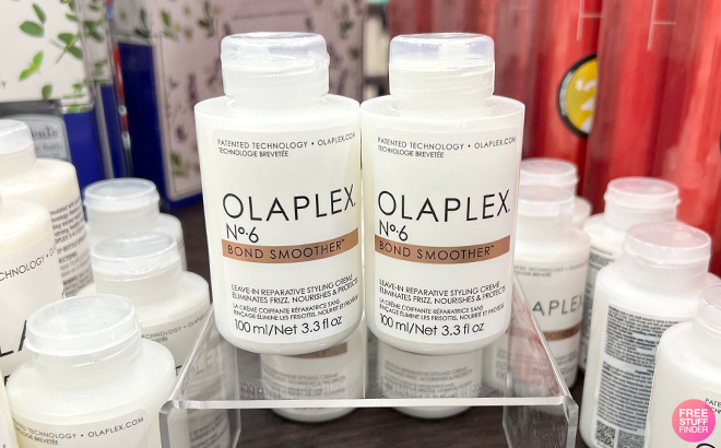 Two Bottles of Olaplex No 6 Bond Smoother on a Product Display Stand jpg