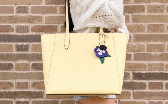 Woman Wearing Kate Spade Dana Tote in Butter Color