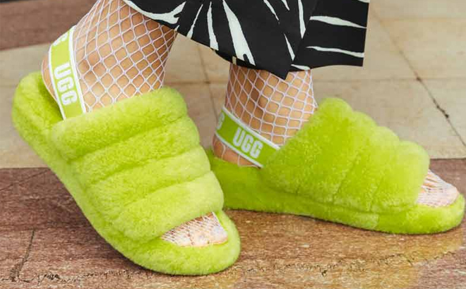 Woman Wearing UGG Fluff Yeah Slingback Sandals in Neon Green Color