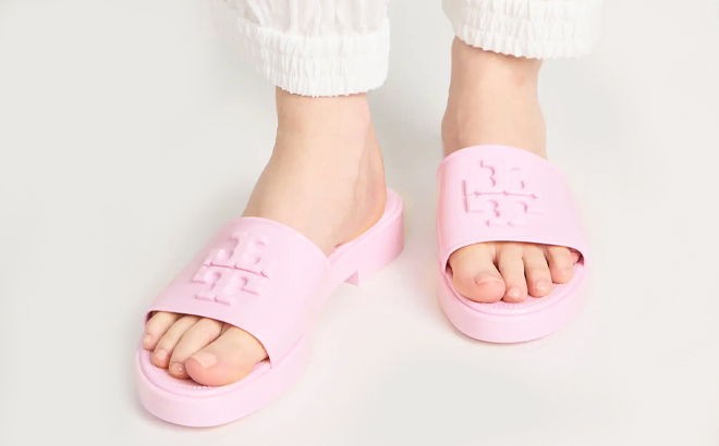 Woman wearing Tory Burch Eleanor Jelly Slides in Petunia Color