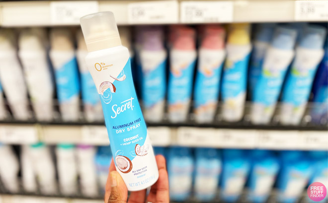 a Person Holding a Secret Dry Spray Deodorant in a Store