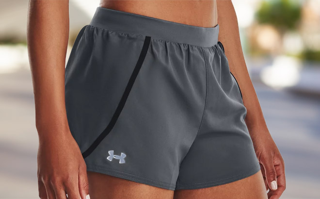 a Person wearing a Pitch Grey Color Under Armour Womens Mileage 3 0 Shorts