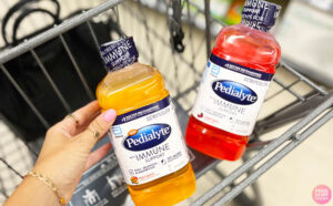 a Person with Two Different Flavors of Pedialyte Immune Support Electrolyte Hydration Drinks