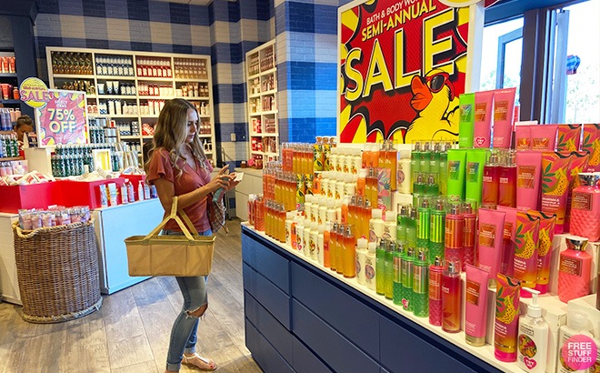woman browsing bath and body works semi annual sale products