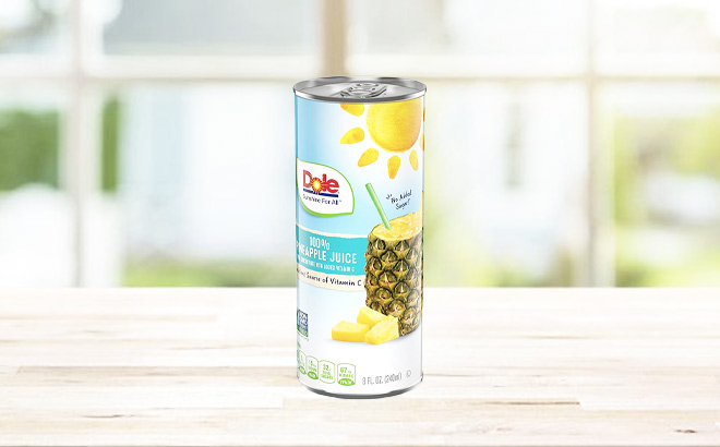A Can of Dole 100% Pineapple Juice on a Table A Can of Dole 100% Pineapple Juice on a Table