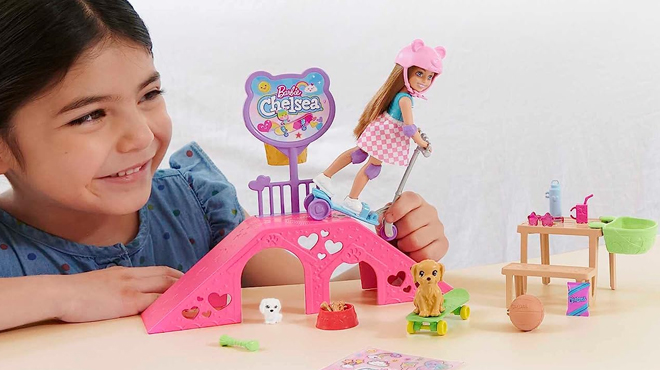 A Girl Playing with Barbie Chelsea Doll and Skate Park Playset