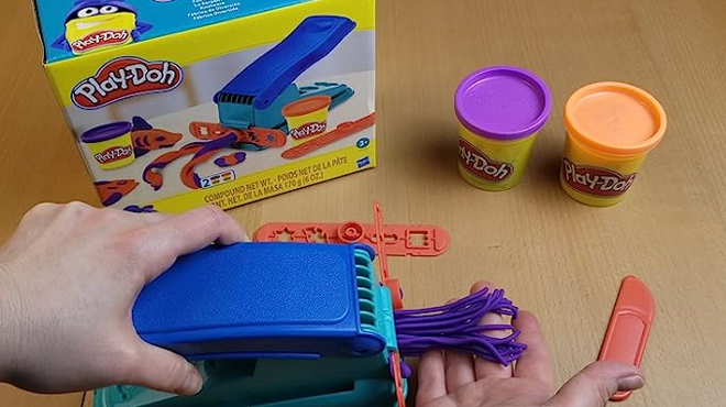 A Person Playing with Play Doh Shape Making Machine A Person Playing with Play Doh Shape Making Machine