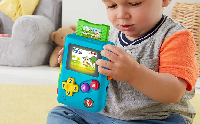 Baby Holding Fisher Price Lil Gamer Pretend Video Game 1