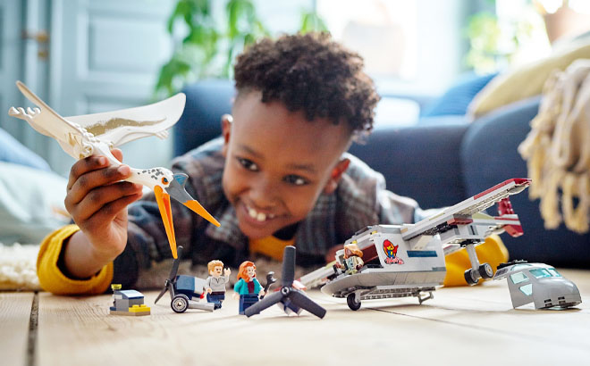 Boy Playing LEGO Jurassic World Quetzalcoatlus Plane Ambush 306 Piece Set