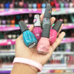Hand Holding Sinful Colors Nail Polish in Different Colors