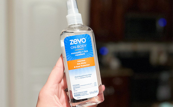 Hand Holding Zevo On Body Mosquito Tick Repellant