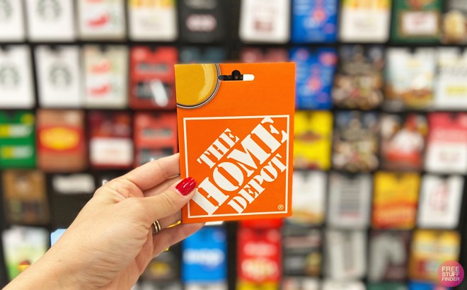 Hand Holding a The Home Depot Gift Card Inside a Store