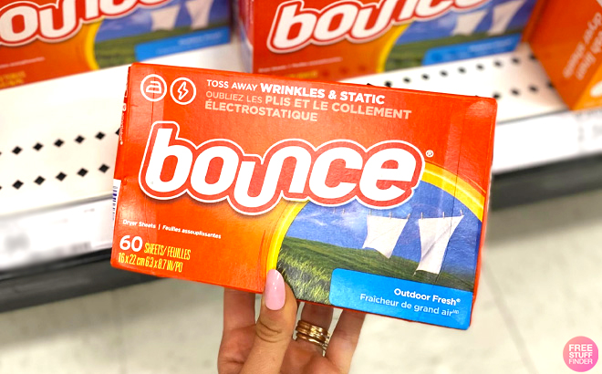 Hand Holding one Bounce Dryer Sheet 60 Count