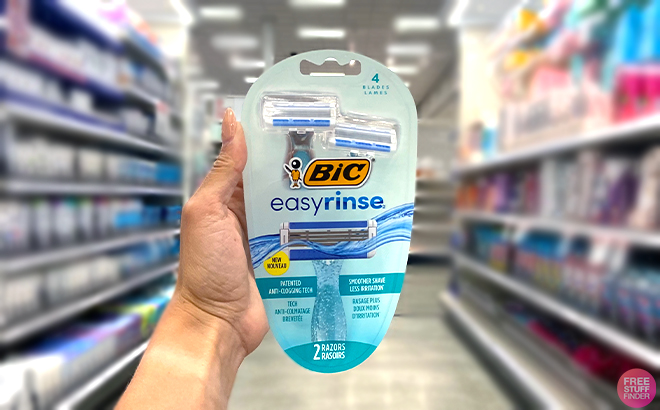 Hand holding one BIC EasyRinse Disposable Razors 2 Count