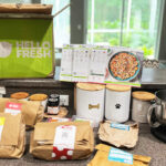 Hello Fresh Box next to Ingredients and Food Mixer on a Kitchen Counter