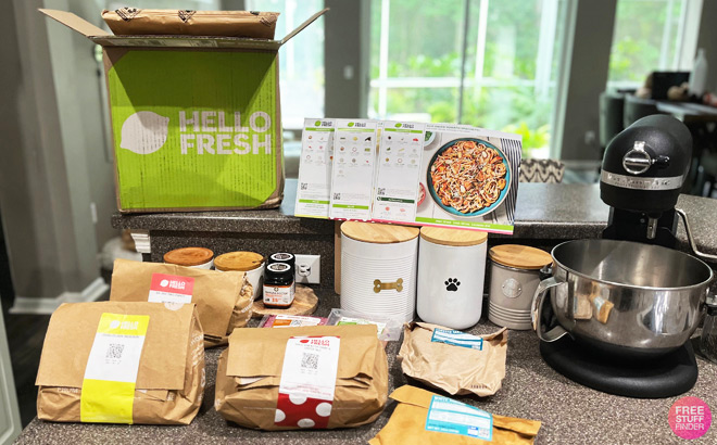Hello Fresh Box next to Ingredients and Food Mixer on a Kitchen Counter