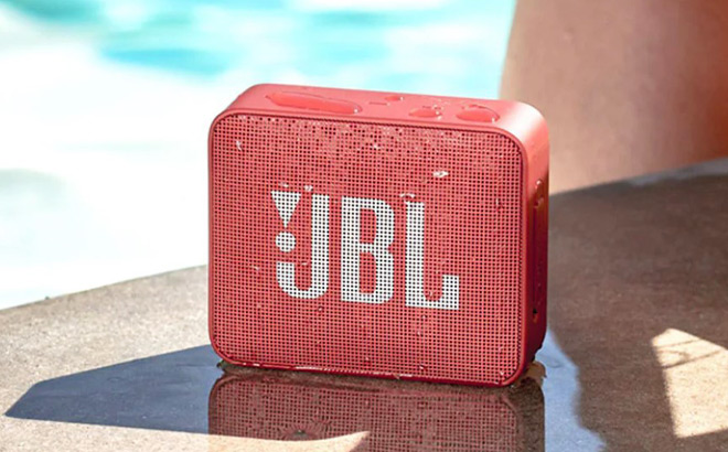 JBL GO2 Portable Bluetooth Speaker beside a Swimming Pool