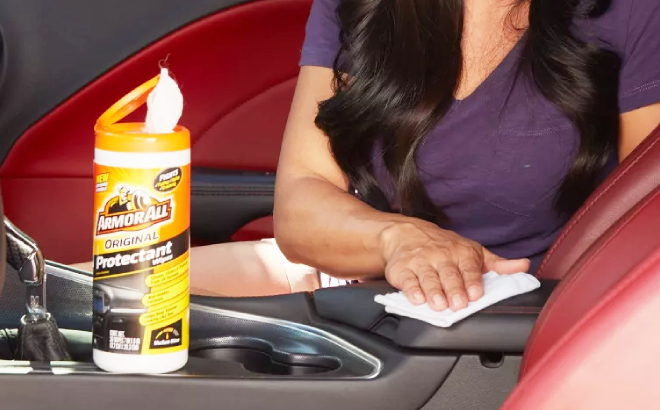 Lady Cleaning Car Using Armor All Cleaning Wipes