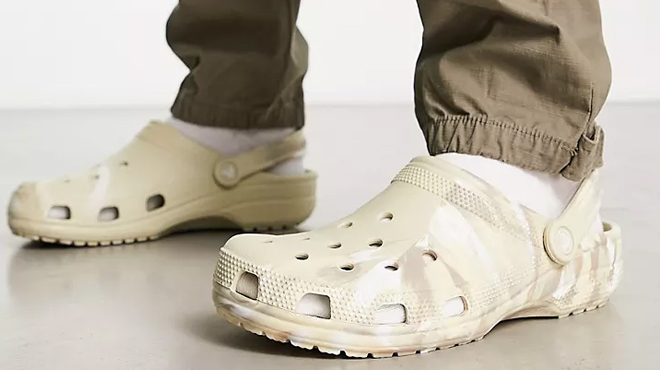 Man Wearing Crocs Classic Marbled Clogs in Bone Color