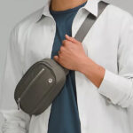 Man Wearing Lululemon Wunderlust Belt Bag in Grey Sage Color