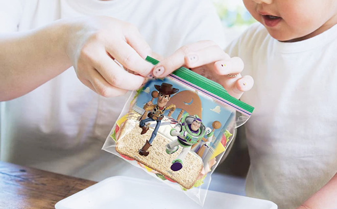 A Person Opening a Ziploc Pixar Sandwich Bag for a Child