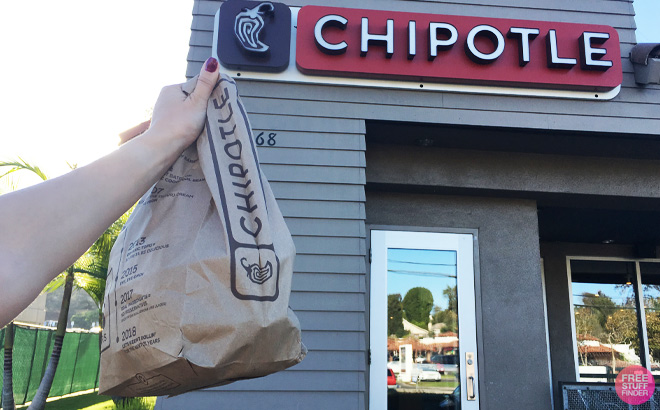 Person Holding Chipotle Bag in front of Chipotle Store