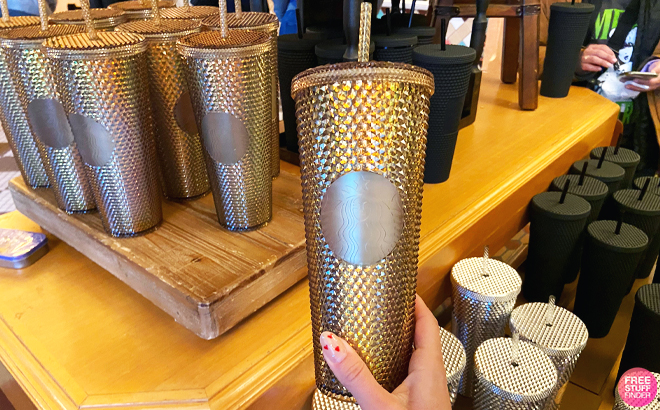Person Holding Disney Starbucks Geometric Gold Tumbler with Straw