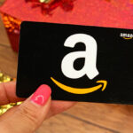 Person Holding a Black Amazon Gift Card