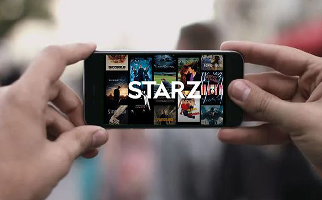 Hands Holding a Phone with the Starz App Opened