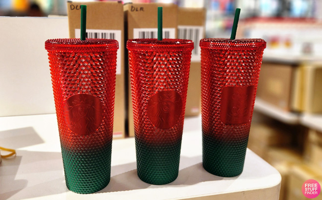 Three Disney Mickey Mouse Christmas Starbucks Tumblers with Straw on a Table