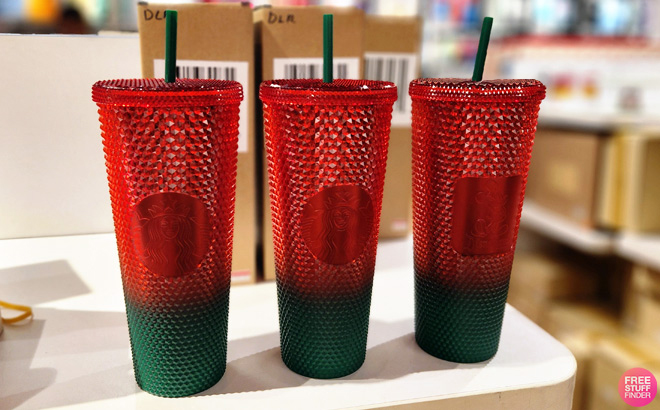 Three Disney Mickey Mouse Christmas Starbucks Tumblers with Straw on a Table Three Disney Mickey Mouse Christmas Starbucks Tumblers with Straw on a Table