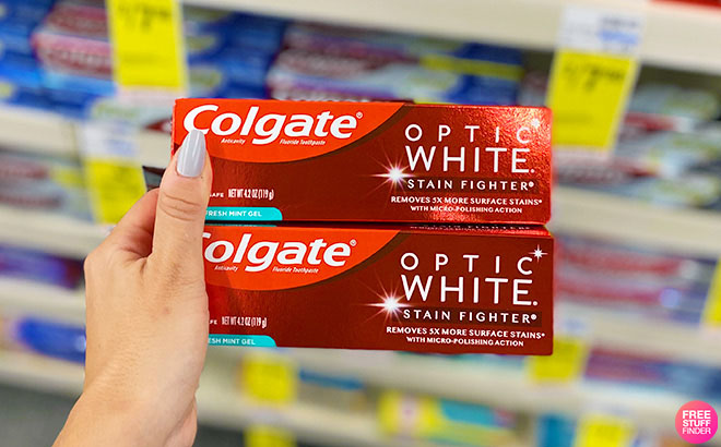 Woman Holding 2 Colgate Optic White Toothpaste