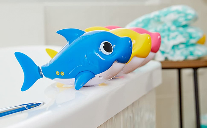 ZURU ROBO ALIVE JUNIOR Baby Shark Battery Powered Sing and Swim Bath Toys on a Bathtub