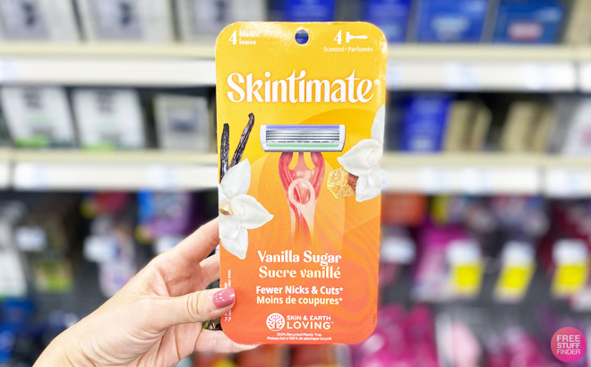 a Hand Holding Skintimate 4 Count Razor Pack