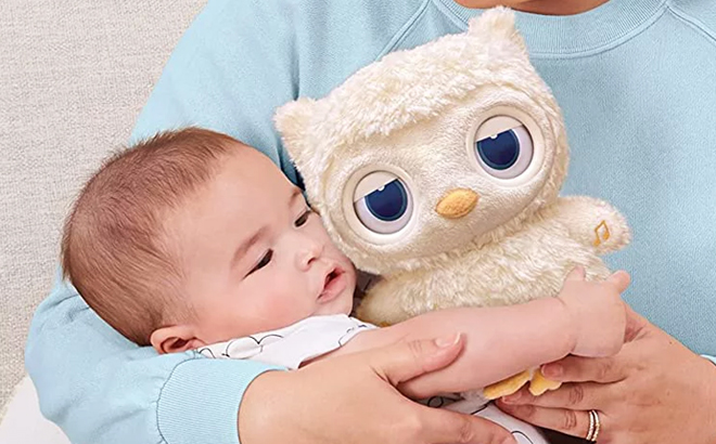 A Baby Hugging Gund Night Light and Sound Machine Owl Plush