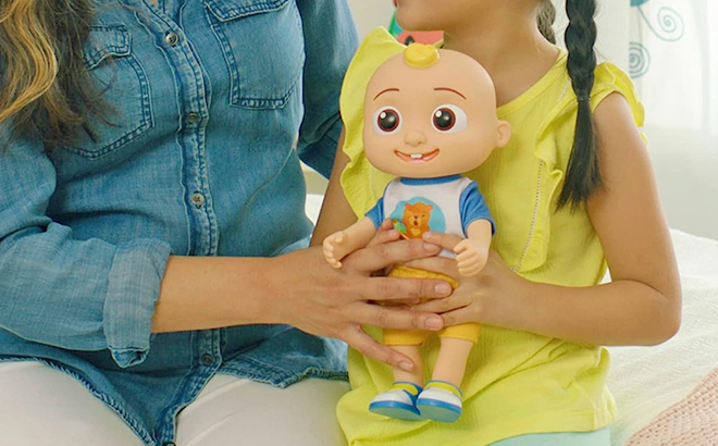 A Child Holding a Cocomelon Deluxe Interactive JJ Doll