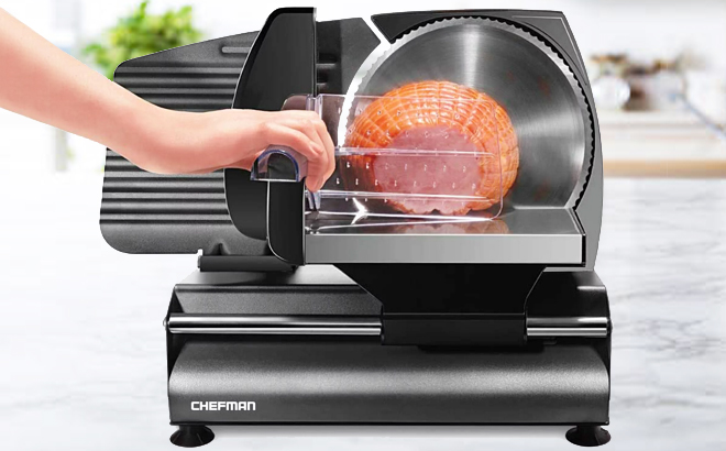 A Hand Holding Chefman Die Cast Electric Meat and Deli Slicer