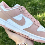 A Hand Holding Nike Dunk Low in Rose Whisper Color