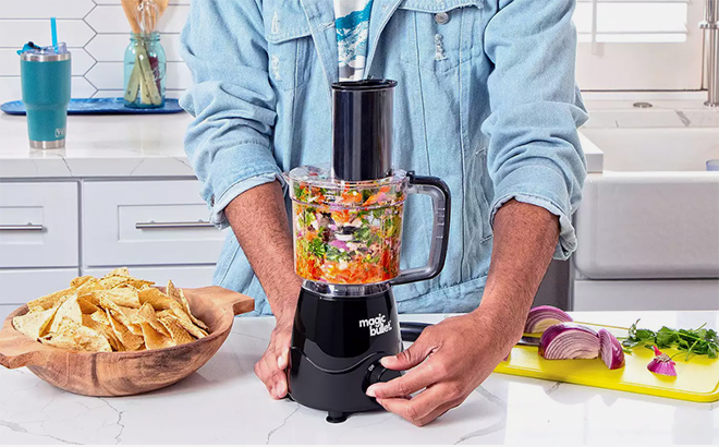 A Man Using the NutriBullet Magic Bullet Kitchen Prep Food Chopper in the Kitchen A Man Using the NutriBullet Magic Bullet Kitchen Prep Food Chopper in the Kitchen