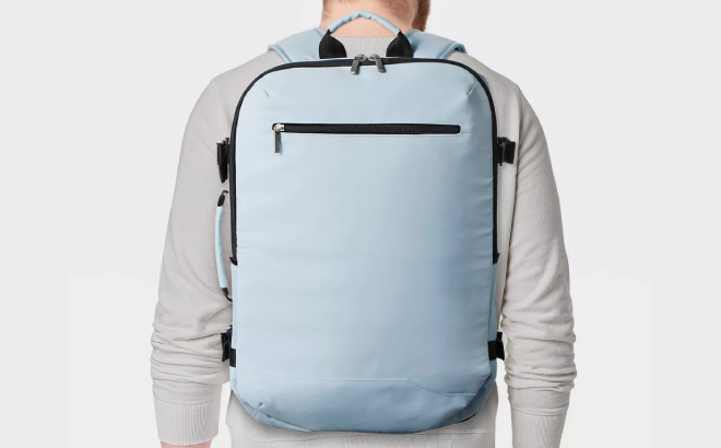 A Person Carrying an Open Story 35L Travel Backpack